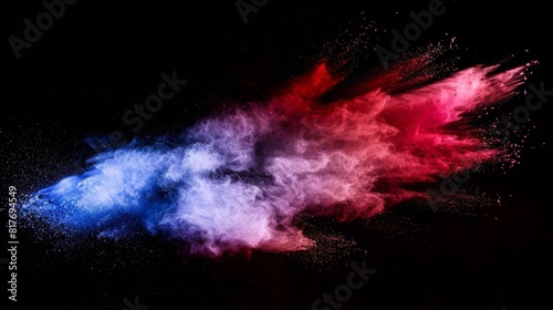 A vibrant burst of blue and red powder creates an impactful contrast against the dark backdrop, evoking energy and motion