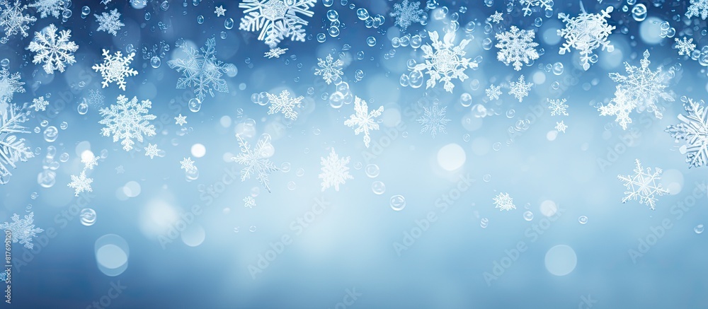 A copy space image featuring snowflakes in white set against a backdrop of blue
