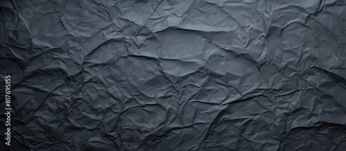 The dark paper with a creased texture serves as the background for the copy space image