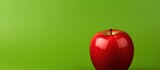 A copy space image showcasing a vibrant green apple against a contrasting red background