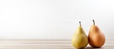 A single pear is displayed on a white wooden table with a background that offers ample copy space for additional elements
