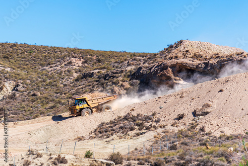 Exclusive large tonnage dumper truck for works going down a slope with a load of earth. Earthworks. photo