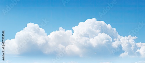 A stunning white cloud floats against a backdrop of a vibrant blue sky creating a mesmerizing copy space image