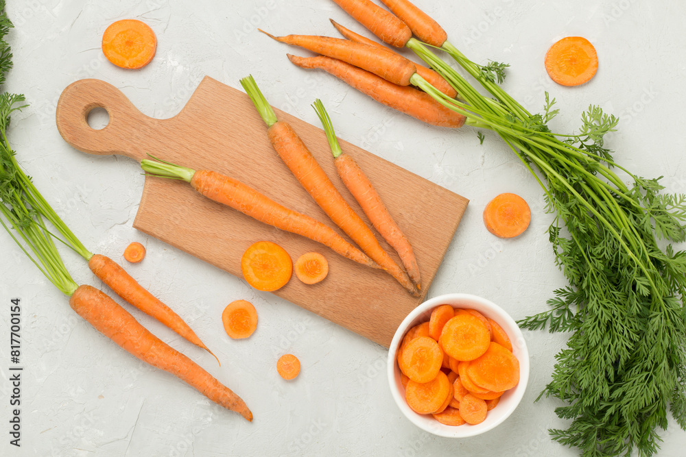 Bunch of fresh carrots with sliced ones on concrete background, top view Bunch of fresh carrots with sliced ones on concrete background, top view