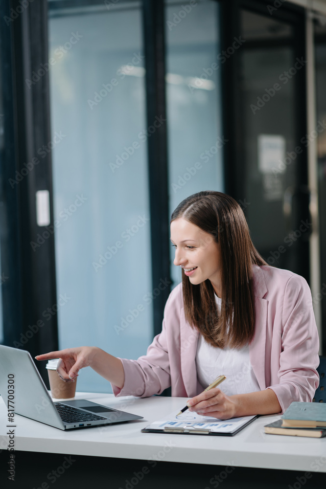 Beautiful Asian business woman typing laptop and tablet Placed at the table . Beautiful Asian business woman typing laptop and tablet Placed at the table .