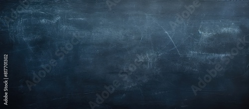 A copy space image of a dark blue chalkboard with traces of erasing creating a textured background photo