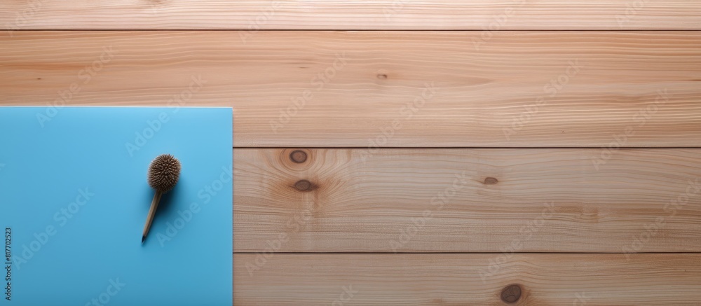 A copy space image featuring a paper note pinned to a wooden background In the scene there is also a blue pin a diary book and a pen A copy space image featuring a paper note pinned to a wooden background In the scene there is also a blue pin a diary book and a pen