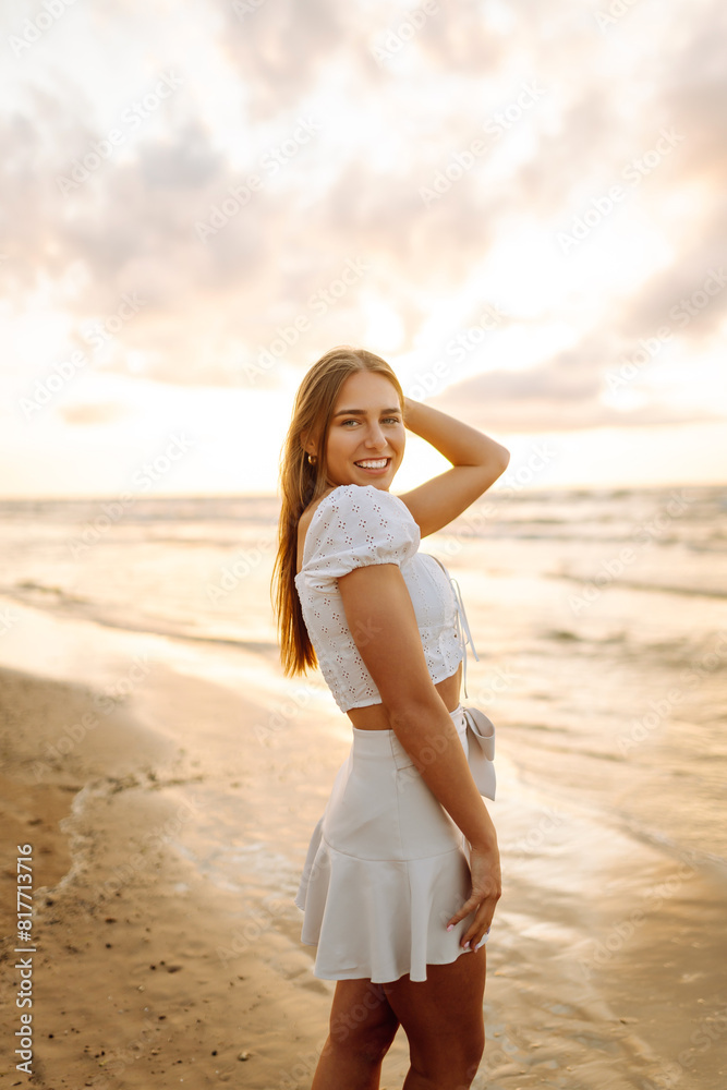 Young woman enjoying looking view of beach ocean on summer day at sunset. Travel, weekend, relax and lifestyle concept. Young woman enjoying looking view of beach ocean on summer day at sunset. Travel, weekend, relax and lifestyle concept.