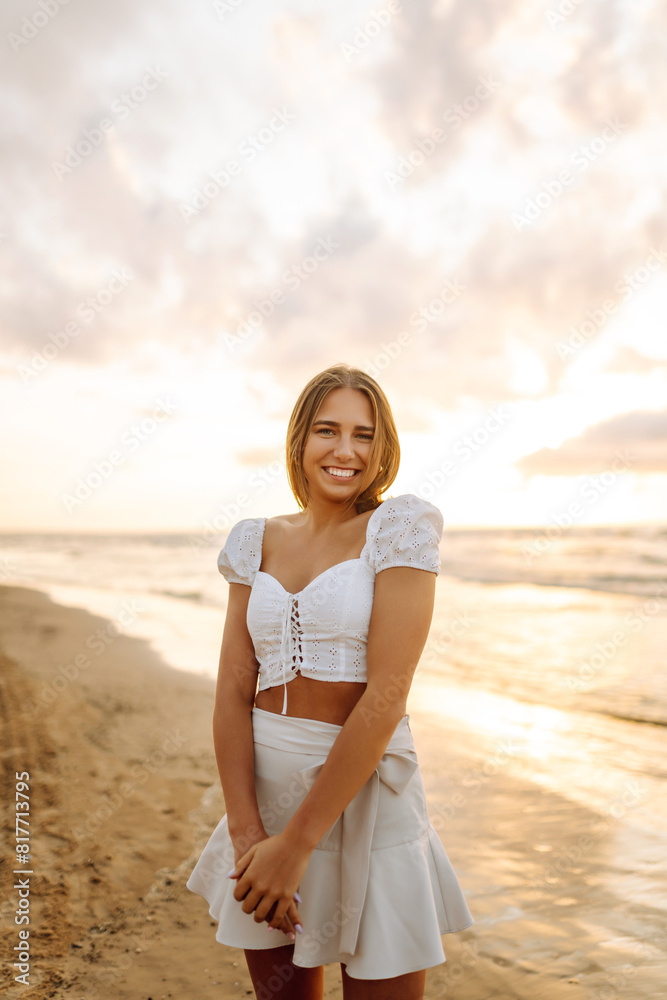 Young woman enjoying looking view of beach ocean on summer day at sunset. Travel, weekend, relax and lifestyle concept. Young woman enjoying looking view of beach ocean on summer day at sunset. Travel, weekend, relax and lifestyle concept.