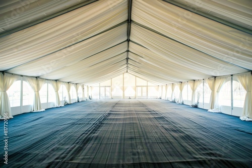 View inside a spacious white tent for weddings or events