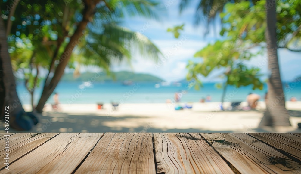 Fototapeta premium Wooden table on a blurry beach background with people ideal for displaying products