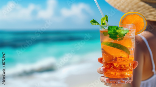 Refreshing Citrus Cocktail Held on a Tropical Beach.