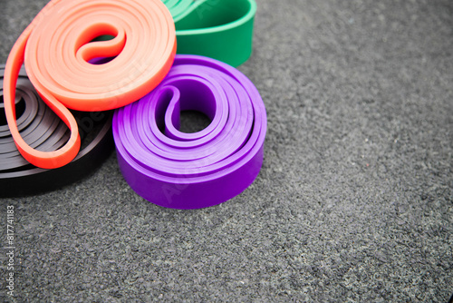 set of colorful elastic fitness bands  on sport ground. Outdoor workouts concept . Copy space , close up view