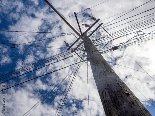 electricity and telephone lines view from the ground many wires cable post view from bottom to up photo