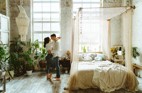 Young couple spending time and dancing and having lovely moments in their beautiful countryside house. © oneinchpunch