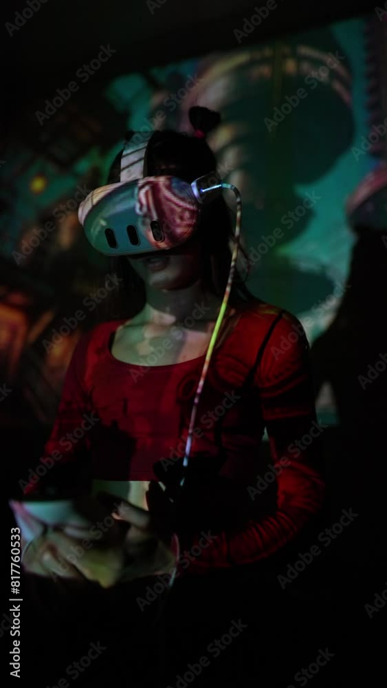 Experience a digital performance: a girl dances with VR goggles at a virtual concert. Experience a digital performance: a girl dances with VR goggles at a virtual concert.
