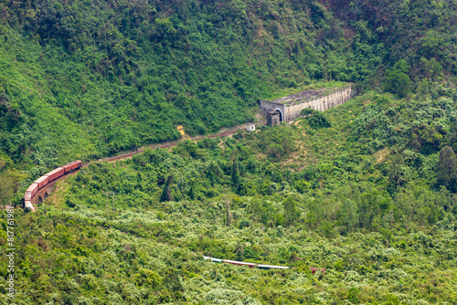 A Long Freight Train Entering Tunnel In Hai Van Pass, Vietnam.