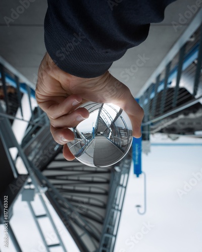 Fototapeta Naklejka Na Ścianę i Meble -  Person outdoors holding a small lens ball reflecting the bridge. Seattle