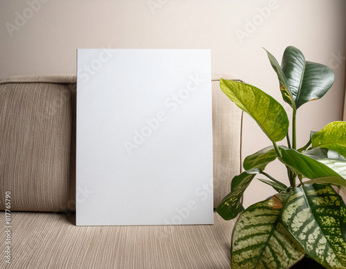 mock up poster frame sits on a gray couch and minimalist background