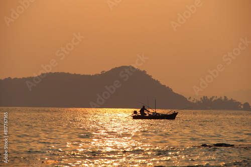 the boat is on a wide ocean and sunset is shining bright