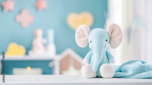 Blue crochet elephant toy in a nursery with pastel decor and wooden toys. 
