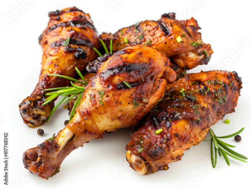 A plate of four chicken legs with herbs and spices