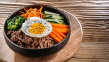 Traditional Korean dish bibimbap with fried agg, beef and vegetables. AI generative