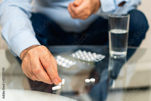 Hands with pills. Senior man hands with medical pill and glass of water. Mature old senior grandfather taking medication cure pills vitamin. Age prescription medicine healthcare therapy concept