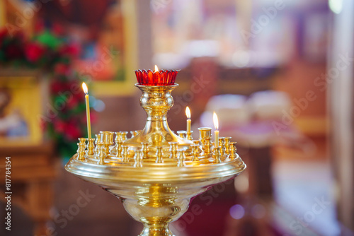 Candles burn in a candlestick in the church. the tranquility and beauty of the church service.