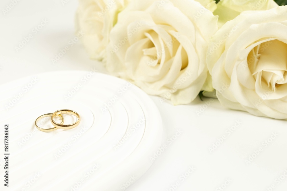 Wedding white roses and gold wedding rings on white background. Wedding composition, white arch tray, podium. Copy space, flat lay. Wedding white roses and gold wedding rings on white background. Wedding composition, white arch tray, podium. Copy space, flat lay.