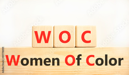 WOC women of color symbol. Concept words WOC women of color on beautiful wooden blocks. Beautiful white background. Business WOC women of color social issues concept. Copy space.