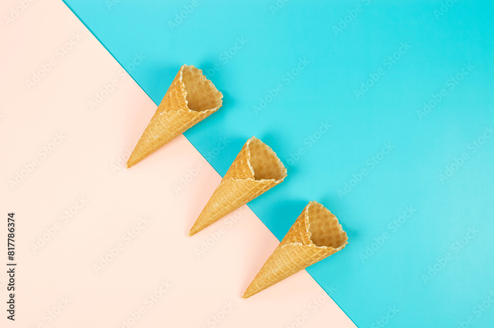 Top view of three ice cream waffle cones on colorful background. Summer wallpaper, flat lay, copy space. Top view of three ice cream waffle cones on colorful background. Summer wallpaper, flat lay, copy space.
