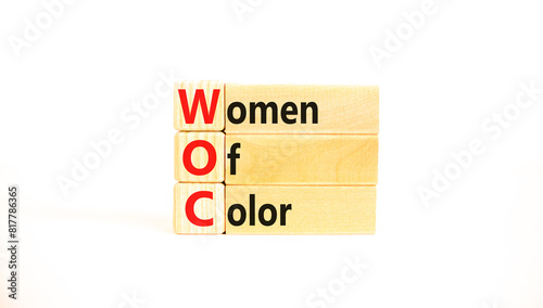WOC women of color symbol. Concept words WOC women of color on beautiful wooden blocks. Beautiful white background. Business WOC women of color social issues concept. Copy space.