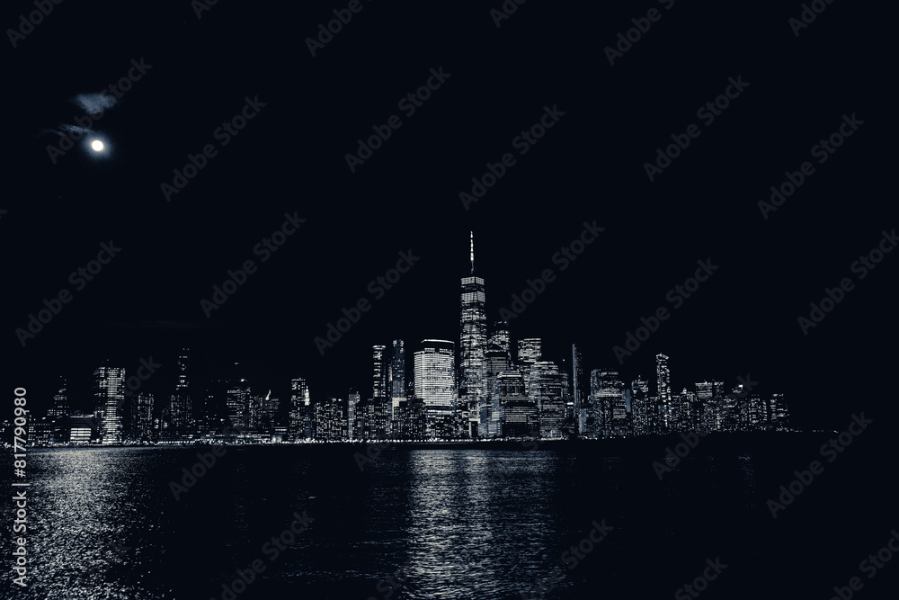 Naklejka premium an illuminated view of a city at night by the water