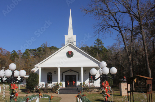 Small White Church in Rural East Texas With Christmas Decorations and Blue Sky photo