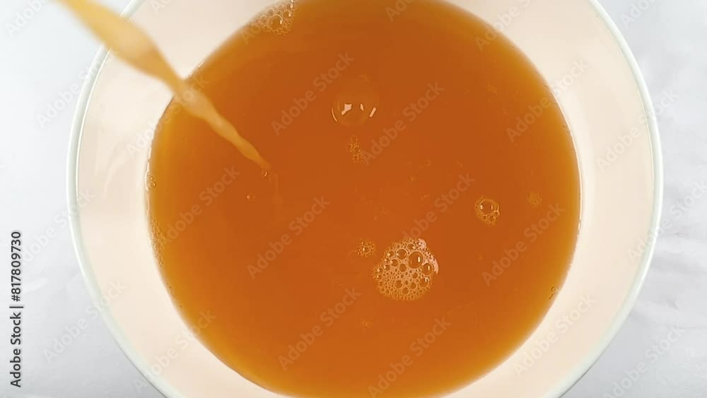slow motion shot of pouring orange juice, fresh organic orange juice in slow motion slow motion shot of pouring orange juice, fresh organic orange juice in slow motion