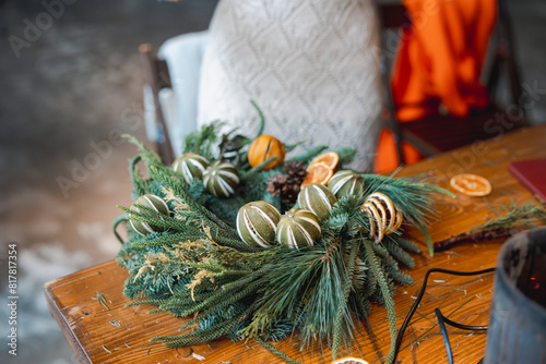 A lovely young lady captivated by a holiday decoration-making masterclass.