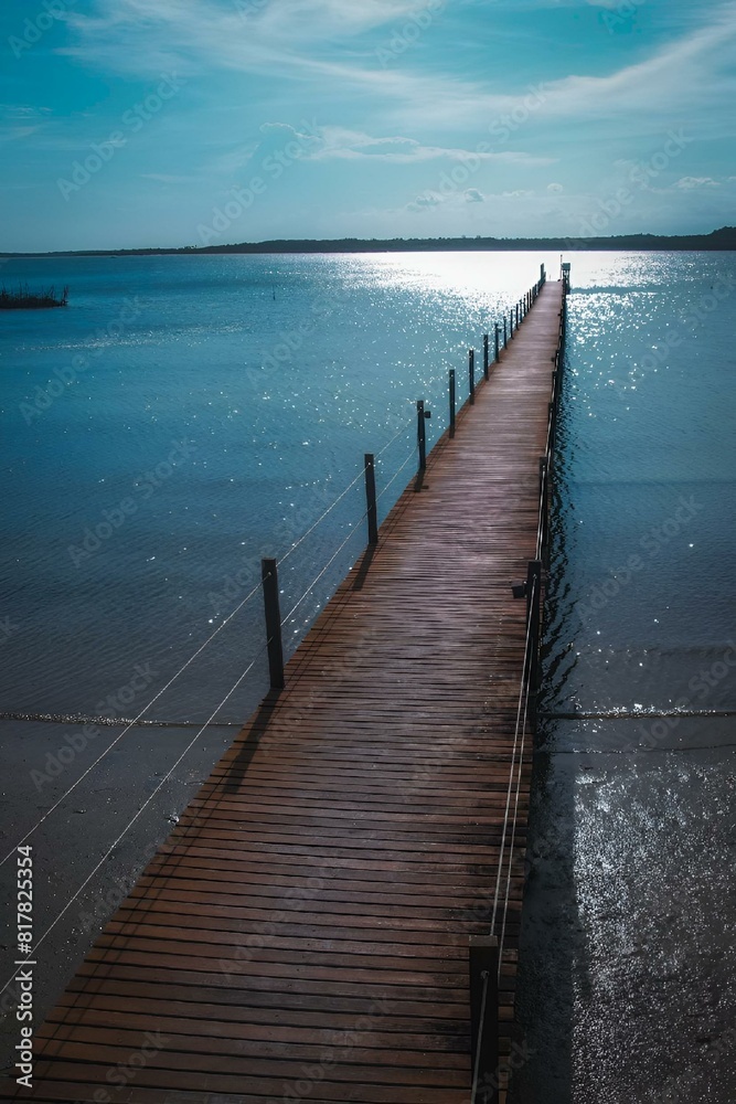 Fototapeta premium a pier that looks very long over the water, and has no boats