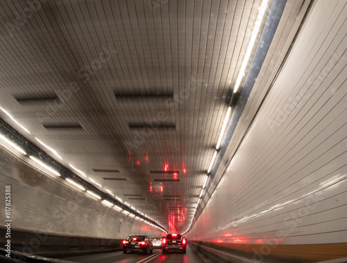 the inside of a tunnel with many cars traveling down it photo