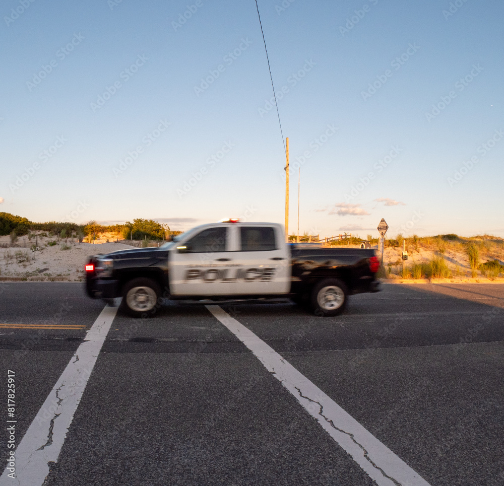 a truck drives down the street with a light on it