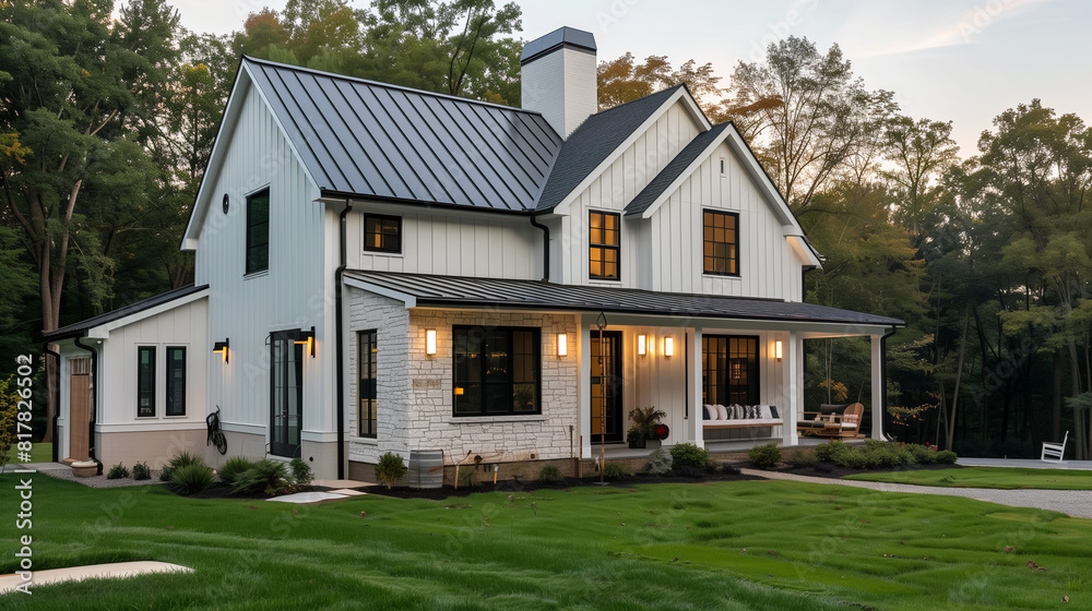 A new, white modern farmhouse with a dark shingled roof and black windows. The left side of the house is covered in a rock siding
