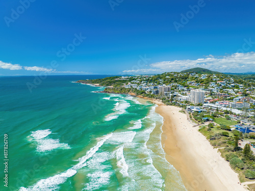 Fototapeta Naklejka Na Ścianę i Meble -  Aerial of the foamy waves of the ocean hitting the sandy shore in Coolum, Sunshine Coast QLD