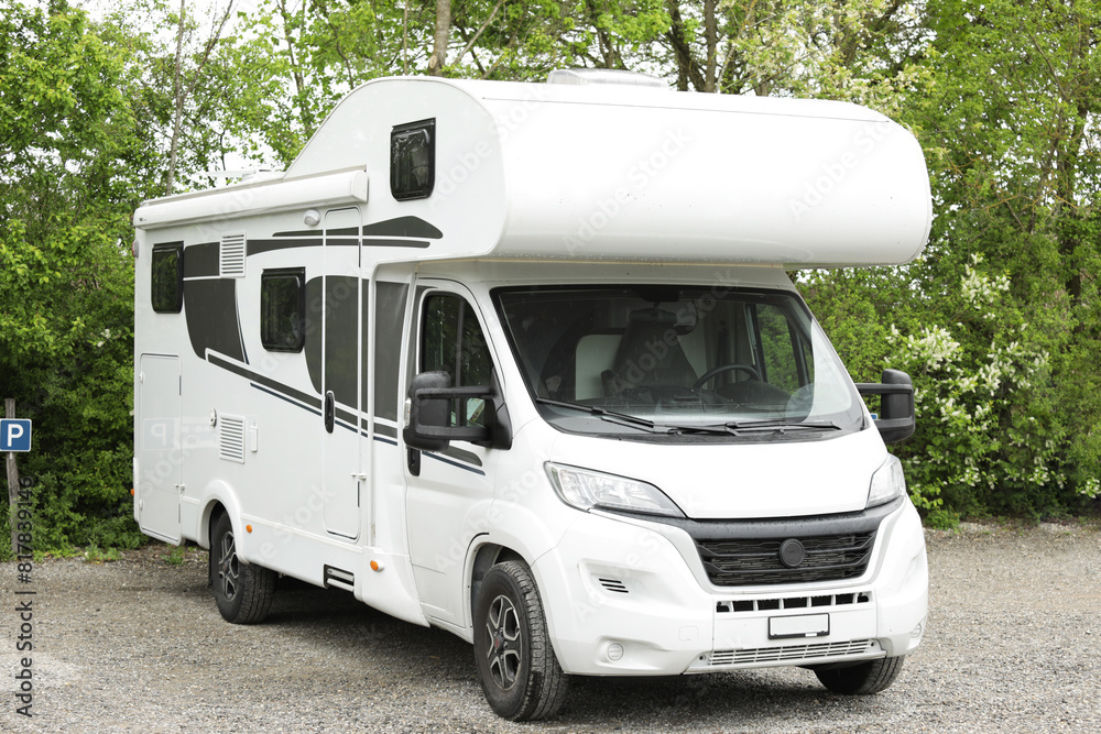 Naklejka premium Family holidays in a motorhome, campervan holidays. Motorhome in the parking lot.