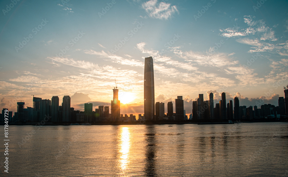 Sunrise on the Wuchang Beach of the Yangtze River, with skyscrapers built on the banks of the river. Sunrise on the Wuchang Beach of the Yangtze River, with skyscrapers built on the banks of the river.