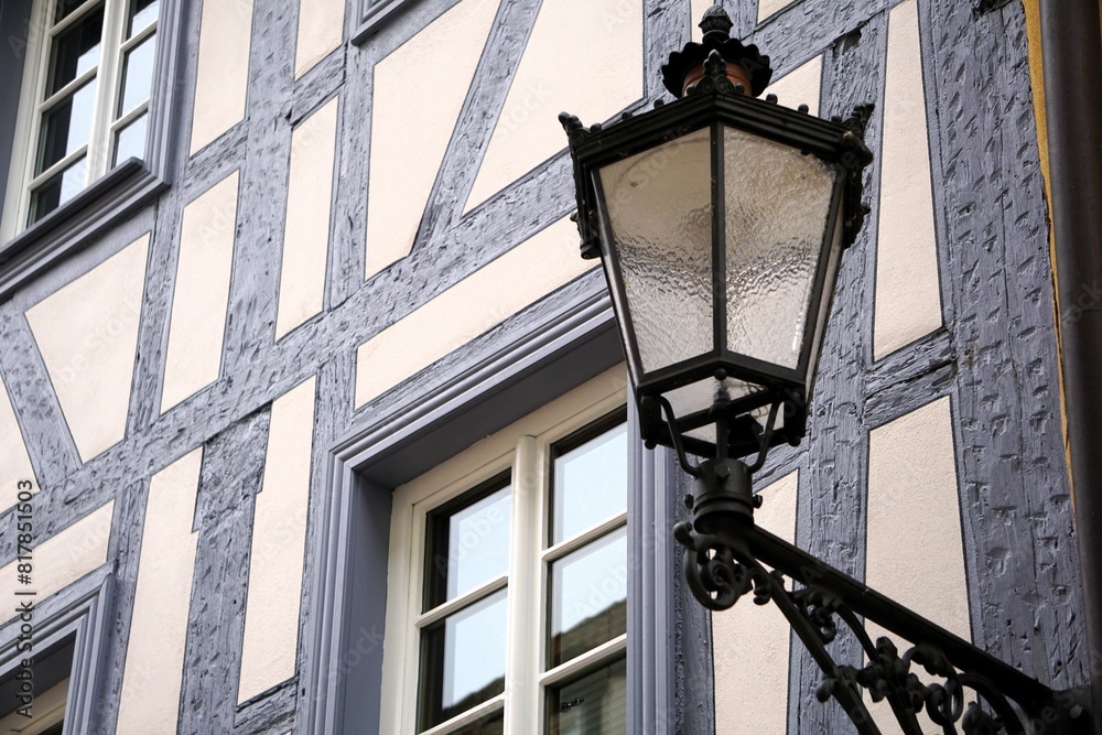 there is a street light and the building has beautiful windows there is a street light and the building has beautiful windows