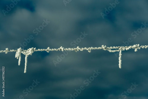 Closeup shot of a wire with a layer of snow