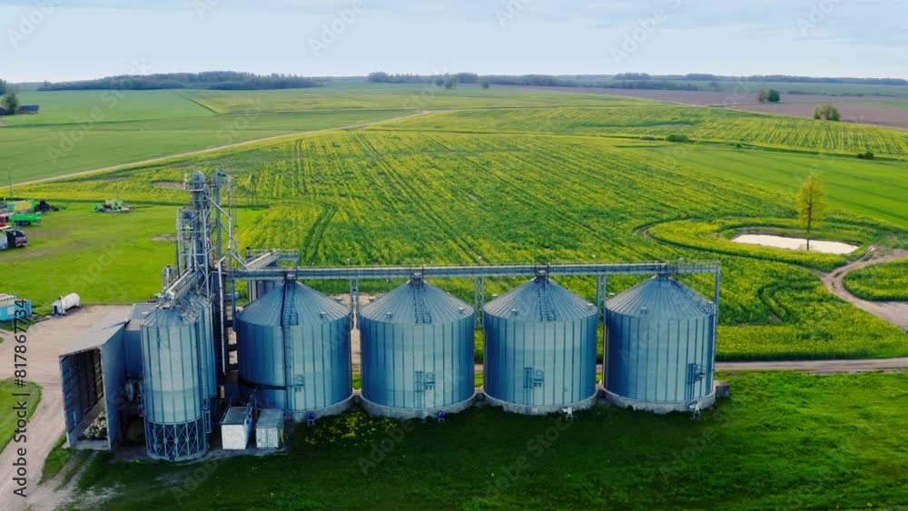 Aerial view of the steel grain silos for grain cleaning, drying and storage. 4k ProRes footage. Aerial view of the steel grain silos for grain cleaning, drying and storage. 4k ProRes footage.