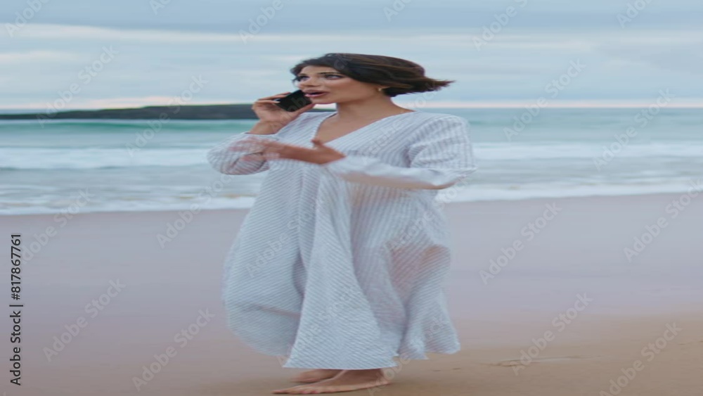 Carefree girl speaking smartphone on ocean beach vertical. Smiling lady calling Carefree girl speaking smartphone on ocean beach vertical. Smiling lady calling