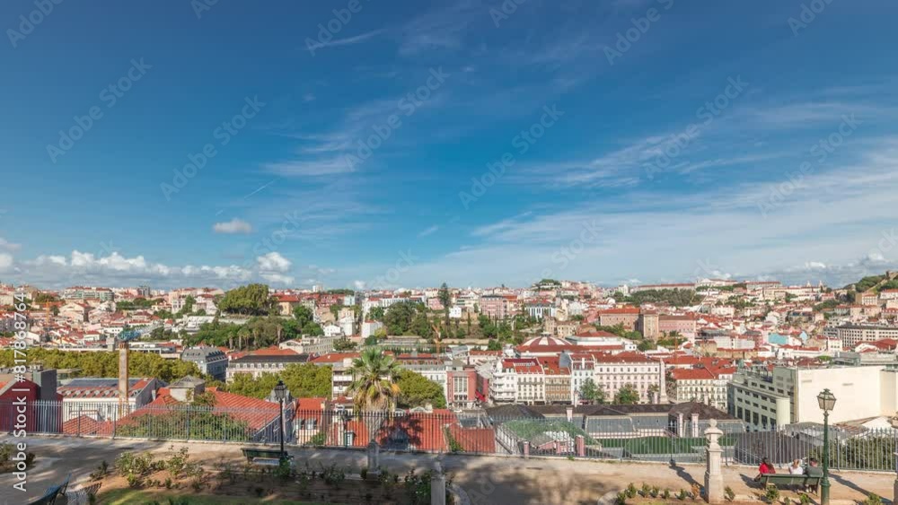 Panorama showing aerial view over the center of Lisbon timelapse from the viewpoint called: Miradouro de Sao Pedro de Alcantara featuring the Baixa neighborhood from above and Castelo Sao Jorge. Panorama showing aerial view over the center of Lisbon timelapse from the viewpoint called: Miradouro de Sao Pedro de Alcantara featuring the Baixa neighborhood from above and Castelo Sao Jorge.