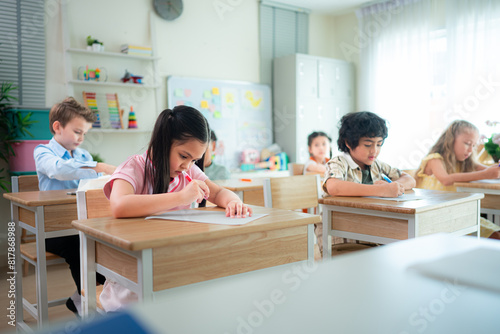 Students learn and study in a classroom of school where youngsters sit and listen attentively.